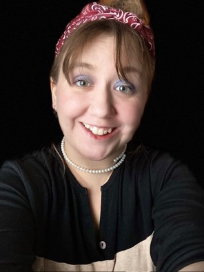 A selfie of a light-skinned woman wearing a red hair band