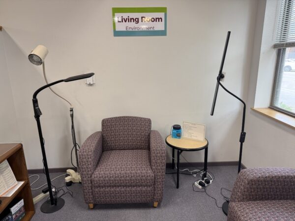 Three floor lamps along with chairs and a side table in the Sharper Vision Store