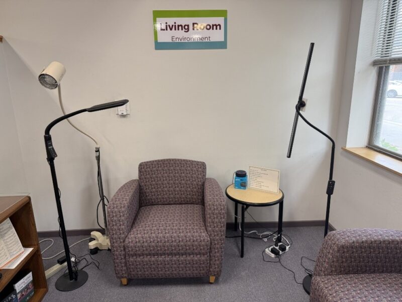 Three floor lamps along with chairs and a side table in the Sharper Vision Store