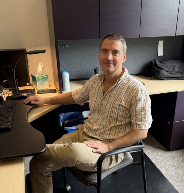 Dan Neff sitting at his desk
