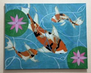 Orange koi fish and lily pads in a pond viewed from above