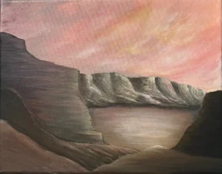 The sun sets on a desert valley