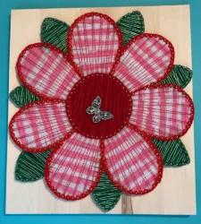 A 3D piece featuring a multi-colored butterfly on a flower