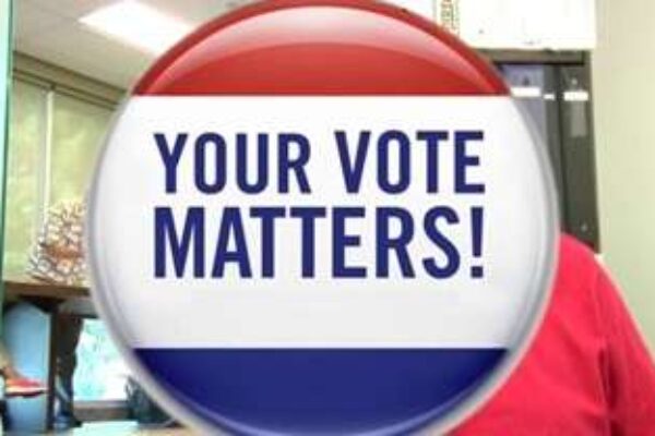 A red white and blue button that says your vote matters